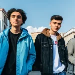 Home 20 조지아의 청년 문화 트렌드 - "A diverse group of young Georgian activists, aged 18-25, stands united on a bustling, modern street...